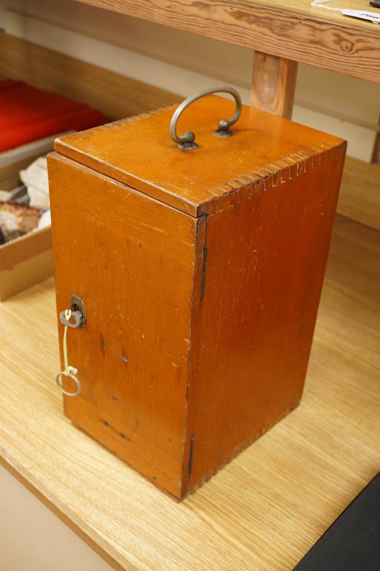 An early 20th century teak cased Ernst Leitz, Wetzlar brass and cast iron monocular microscope, serial no. 268264, with fitted interior to the case and card box of specimen slides, case dimensions; 36cm high, 19cm wide,